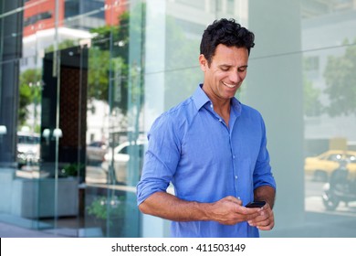 Portrait Of A Business Man Walking With Mobile Phone