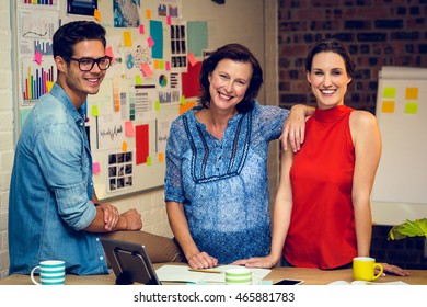 Portrait of business people smiling in office - Shutterstock ID 465881783
