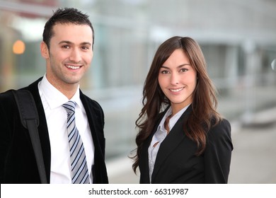 Portrait Of Business People Standing Outside The Airport