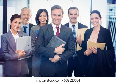 Portrait of business team with document and organizer in office