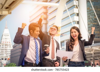 Portrait of Business team raising arms celebrate on blurred city background. Business success concept. - Shutterstock ID 785755423
