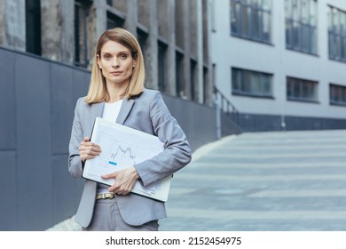 Portrait Of Business Woman, In Gray Suit, Outside Office, Businesswoman With Laptop And Paper Documents