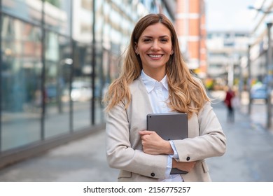 Portrait of a business woman holding tablet in hands - Powered by Shutterstock