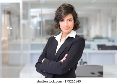 Portrait Of A Business Woman In An Office. Crossed Arms