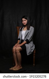 Portrait Business Woman Sitting At Chair With Dark Background. Bangkok Thailand. February 11, 2021