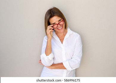 Portrait of business woman smiling and holding glasses
