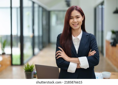Portrait of a business woman standing with her arms crossed.