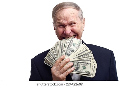 Portrait Of Businessman biting cash. Greedy mature man biting dollar bills with his teeth  isolated on white. 