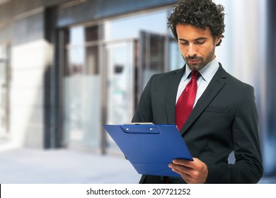 Portrait Of A Businessman Holding A Clipboard