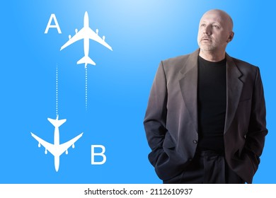 Portrait businessman next to silhouettes of airplanes. Concept thinks about business travel itinerary. Businessman chooses air flights. He was going on air travel. Air flight from point a to point b