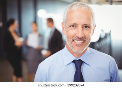 Portrait Of Businessman Smiling In Office