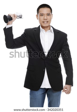 Portrait of a businessman standing with trophy on the white background.