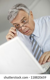 Portrait Of Businessman With Suprised Look In Front Of Laptop