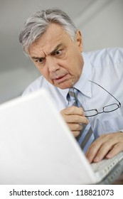 Portrait Of Businessman With Suprised Look In Front Of Laptop