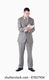 Portrait Of A Businessman Taking Notes Against A White Background