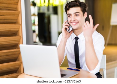 Portrait Of Businessman Talking On Mobile Phone In Office. Phone Sales