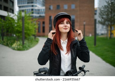 Portrait Of Businesswoman Commuter On The Way To Work Putting On Cycling Helmet, Sustainable Lifestyle Concept.