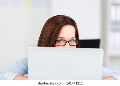 Portrait Of Businesswoman Looking Over At The Computer Monitor