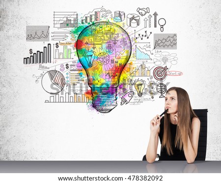 Portrait of businesswoman sitting near concrete wall with colorful light bulb sketch and diagrams. Concept of statistician work