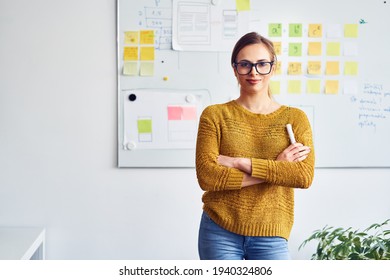 Portrait of businesswoman standing in front of whiteboard in office
