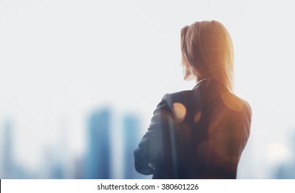 Portrait of businesswoman in suit. Blurred city background. Horizontal