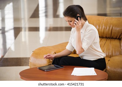 Portrait Of Busy Business Woman Working On Ipad While Sitting At Sofa. Small Business.