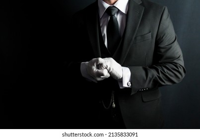 Portrait of Butler in Dark Suit and White Gloves Eager to be of Service. Concept of Professional Hospitality and Courtesy.