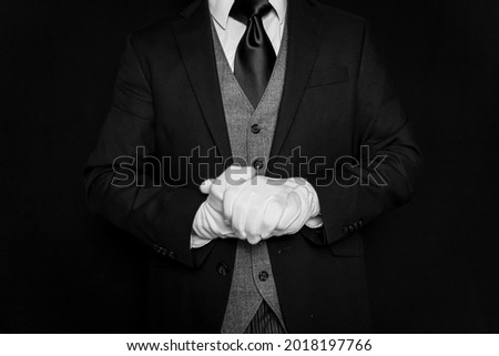 Portrait of Butler in Dark Suit and White Gloves Eager to be of Service. Concept of Service Industry and Professional Hospitality.