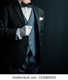 Portrait of Butler or Hotel Concierge in Formal Suit and White Gloves Standing at Respectful Attention. Copy Space for Service Industry and Professional Courtesy.