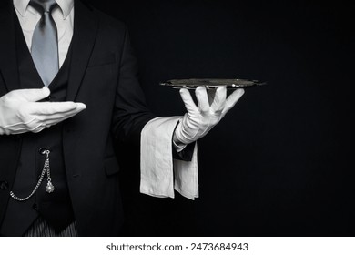 Portrait of Butler or Waiter in Dark Suit and White Gloves Holding Serving Tray. Professional Courtesy and Service Industry.