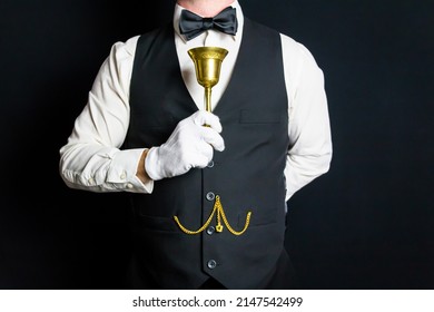 Portrait of Butler or Waiter Holding Golden Serving Bell. Concept of Ring for Service. Professional Hospitality and Courtesy.