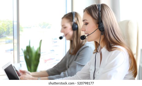 Portrait Of Call Center Worker Accompanied By Her Team. Smiling Customer Support Operator At Work.