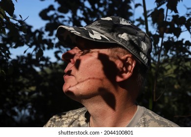 Portrait Of Calm Man Outside, Immersed In Nature, Relaxing And Breathing With Leaves Shadows On His Face.