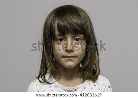 Portrait of a calm and watchful young girl