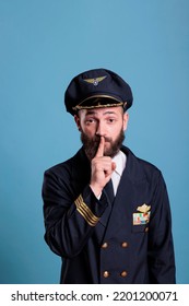 Portrait Of Captain Showing Silent Gesture, Looking At Camera With Forefinger On Lips. Aviation Academy Plane Pilor Front View, Airforce Aviator Keeping Secret, Quiet, Silence Sign