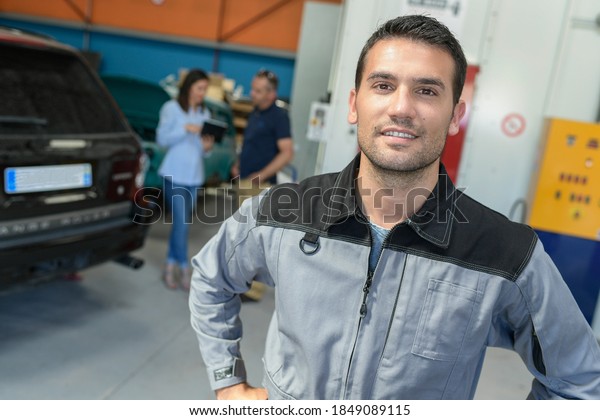 Portrait of a car\
body worker in the\
workshop