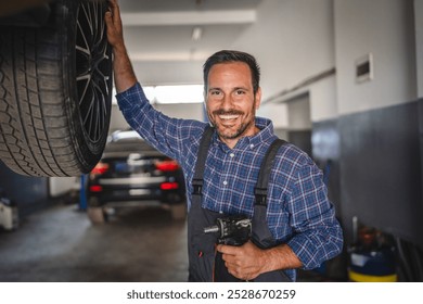 Portrait of car mechanic use a power tool to repair or replace a car wheel while the vehicle is lifted in an automotive repair garage, focusing on precision work - Powered by Shutterstock