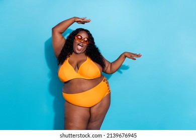 Portrait of carefree chubby afro hairstyle lady enjoy herself dancing no negative attitude fat shaming isolated on blue color background.