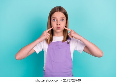 Portrait Of Carefree Excited Girl Pupil Finger Press Pouted Cheeks Hold Breath Isolated On Turquoise Color Background