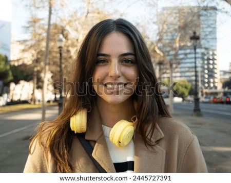Portrait of a carefree smiling young woman in a city. Portrait of empowered woman