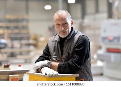 Portrait Of Carpenter Standing In Workshop