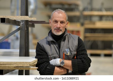 Portrait Of Carpenter Standing In Workshop