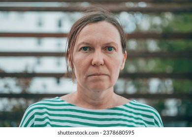 Portrait of casual brunette female at the street, looking at camera, selective focus - Powered by Shutterstock