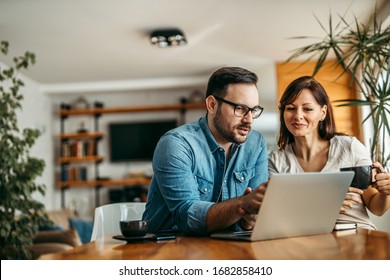 Portrait Of A Casual Business People Looking At Laptop At Workplace.