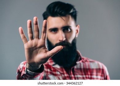 Portrait Of A Casual Man Showing Stop Sign