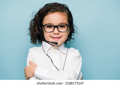 Portrait of a caucasian boy wearing a headset and playing sales representative or customer support on a call center - Powered by Shutterstock