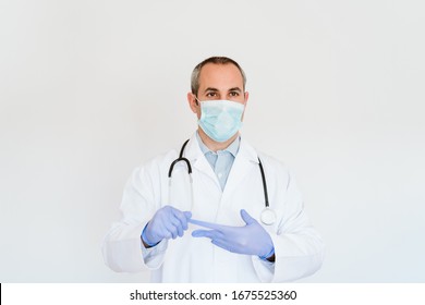 Portrait Of Caucasian Doctor Using Protective Gloves And Mask. Working On A Folder. Chinese Corona Virus Concept. 2019-nCoV