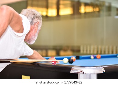 Portrait Caucasian Elder, Senior Mature Man Shooting Game Of Pool Or Billiards.