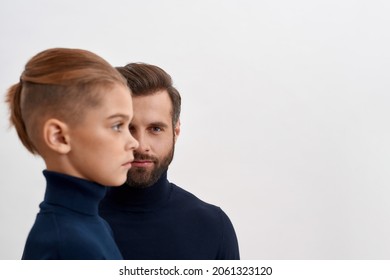 Portrait Of Caucasian Father Look At Camera Isolated On White Studio Background, Small Son Side Face In Front. Two Family Generations Of Men, Dad And Boy Child Kid Show Unity Bonding. Descendant.