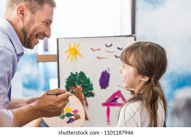 Portrait of caucasian father teaching his daughter little girl to paint and draw picture art class. Home school learn from teacher, education activities family love single dad father’s day concept.